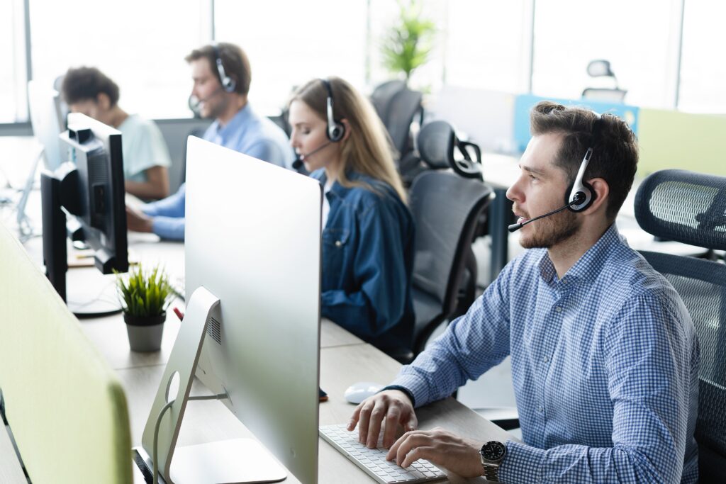 Colleagues working in a call center. People in office for customer service, technical support and advice. Technology, contact us and communication with employee operator in help desk agency